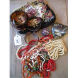 Small evening purse containing a quantity of various necklaces including coral etc