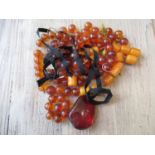 Small re-constituted amber bead necklace and other amber coloured beads etc.