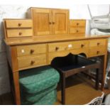 20th Century oak desk having an arrangement of drawers and cupboards over five frieze drawers with