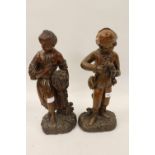 Pair of antique carved fruitwood figures of harvesters, 19ins high