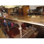 Early 20th Century Continental walnut dining table and two leaves, the moulded pull-out top raised