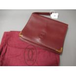 Cartier Pochette bordeaux leather clutch bag, circa 1982, with original dust cover