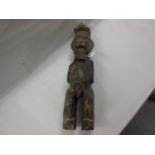Carved African hardwood fertility figure of a bearded man, 25ins high