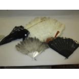 Ostrich feather fan, mother of pearl and feather fan, a black lace fan, together with an ivory and