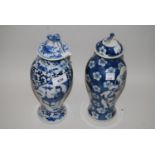 Two Chinese blue and white baluster form covered vases decorated with figures and prunus blossom,