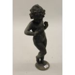 Small lead garden figure of putto on a circular base, 20.5ins high Repair to arm and does have