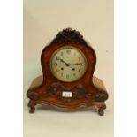 20th Century continental burr walnut mantel clock with a silvered dial, arabic numerals and two