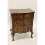 Small 20th Century figured walnut serpentine fronted chest of three graduated drawers with brass