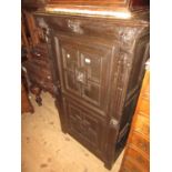 19th Century Continental narrow oak side cabinet, the moulded top above panelled door flanked by