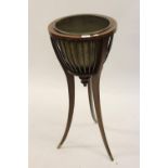 Edwardian mahogany line inlaid jardiniere stand with brass insert on splay tapering supports,