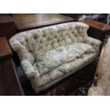 Victorian button upholstered two seat sofa, the rolled back above an overstuffed seat on turned