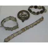 Three various silver coin bracelets and a silver plated dog motif brooch