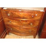 19th Century mahogany bow front chest, the flush top above three graduated drawers with ring handles