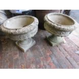 Pair of weathered cast concrete circular pedestal garden planters with detachable bases, 17ins high