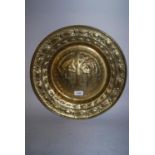 Antique brass alms dish, the centre panel repousse decorated with Adam and Eve naked beneath a tree,