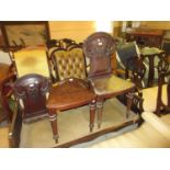 Pair of early Victorian mahogany hall chairs with panelled back and seats on turned front