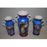 Garniture of three Paris porcelain two handled vases decorated with panels of figures on a blue