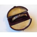 Victorian gold bangle, blue enamel decorated and set with a band of seed pearls, boxed