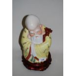 20th Century Chinese porcelain figure of a sage on a hardwood stand