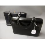 Two vintage black leather handbags