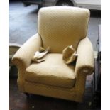 Modern beige upholstered armchair on turned mahogany supports with brass castors (made by Marks