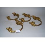 Set of four late 19th / early 20th Century gilt brass curtain tie backs in Adam style