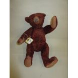 Early 20th Century red plush teddy bear with glass eyes, pointed snout and jointed limbs, 16ins high