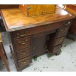 Small George III mahogany kneehole desk with moulded top above eight drawers surrounding a central