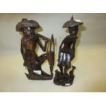 Pair of 20th Century Far Eastern carved hardwood figures of fishermen, 12.25ins high