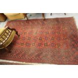 Afghan rug with four rows of twelve gols with multiple borders on wine ground, approximately 84ins x