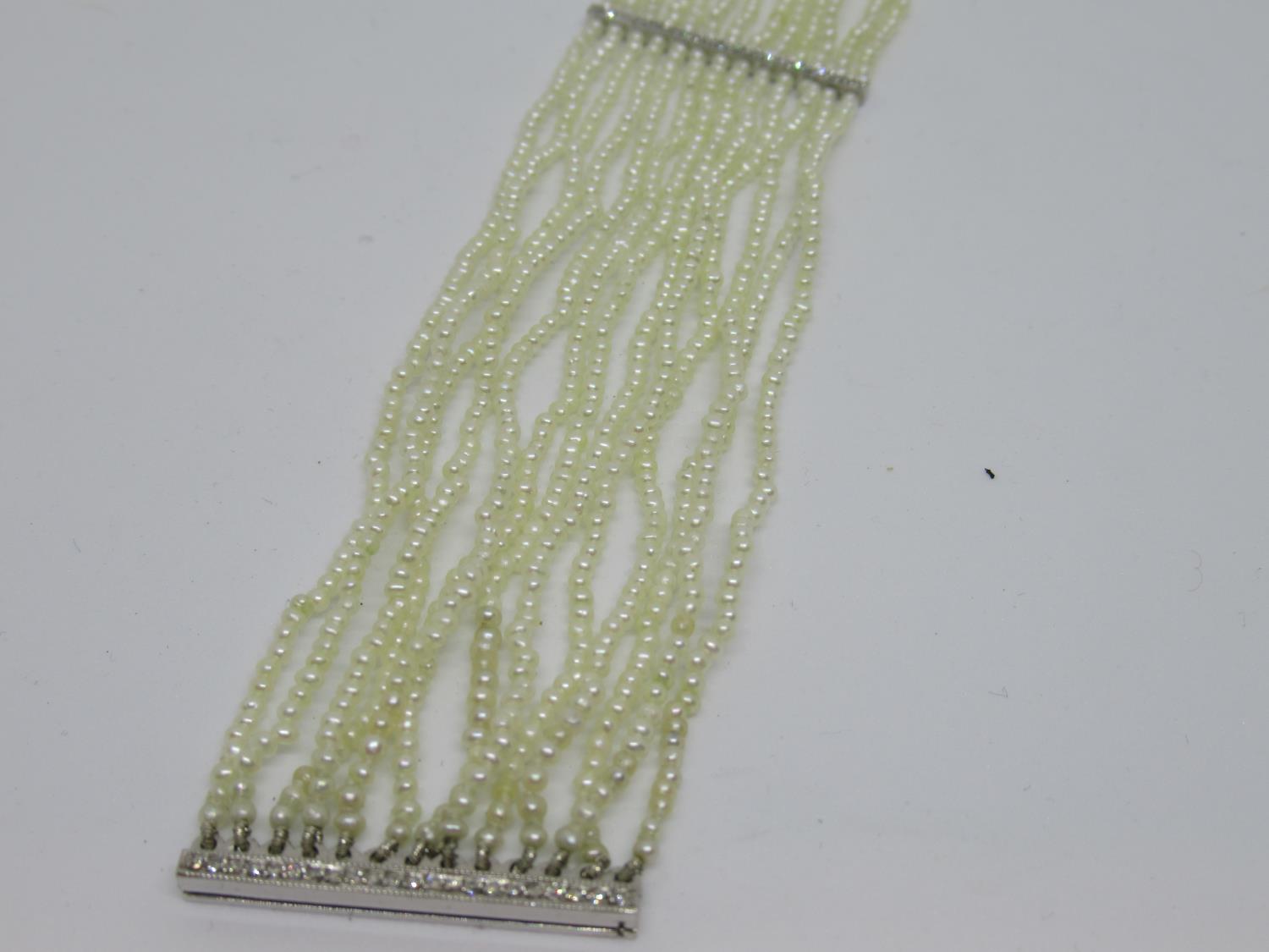 1920's French thirteen row seed pearl choker with diamond set platinum spacers Overall length 31cm - - Image 2 of 3