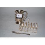 Silver baluster form Christening mug, silver toast rack and a butter knife