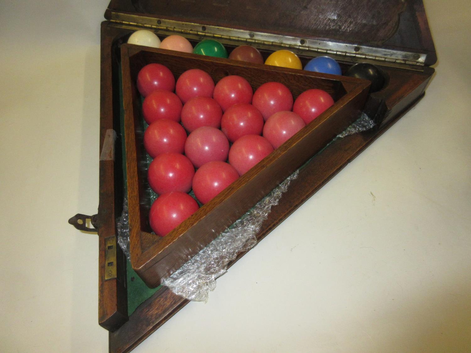 Set of early to mid 20th Century composite snooker balls, housed in a mahogany triangular cabinet - Image 2 of 2