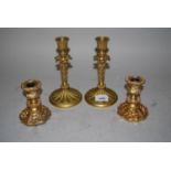 Pair of Regency ormolu candlesticks, 7.25ins high (drilled to bases) together with a pair of later