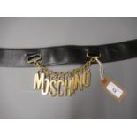 Moschino ladies leather belt with gilt metal hanging logo on chain