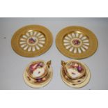 Pair of Aynsley circular floral decorated wall plates with gilded borders, together with two Aynsley