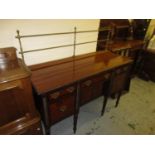 George III mahogany sideboard having brass galleried back above three short drawers and central