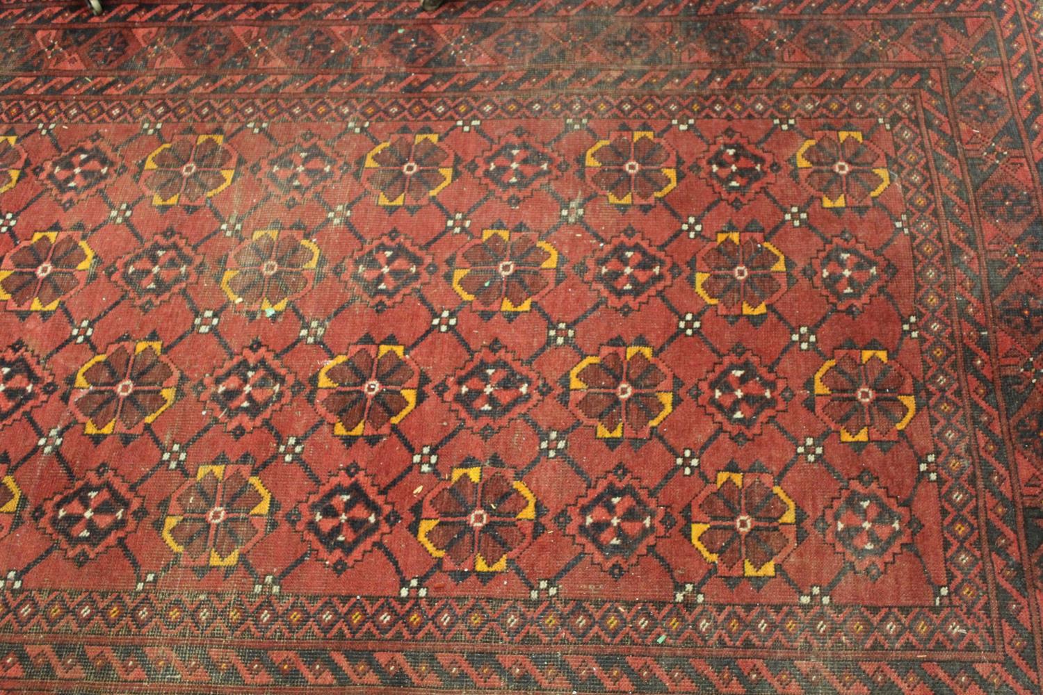 Afghan rug with four rows of twelve gols with multiple borders on wine ground, approximately 84ins x - Image 2 of 2