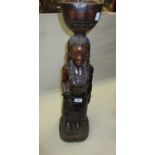 20th Century carved hardwood figure of a woman with bowl on her head, 27.5ins high