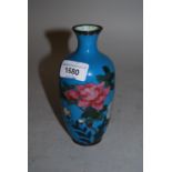 Small cloisonne vase decorated with flowers on a turquoise ground, 5.75ins high
