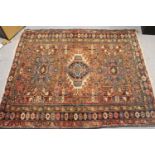 Karaja rug with a triple medallion and all-over stylised design on a rose ground with triple border,