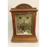 Edwardian oak mantel clock, the gilt dial with a silvered chapter ring, Roman numerals, slow /