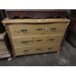 19th Century Continental stripped pine chest with a serpentine top above three drawers on shaped