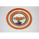 Clarice Cliff Fantasque plate decorated with stylised flowering lotus, 10.5ins diameter Some crazing