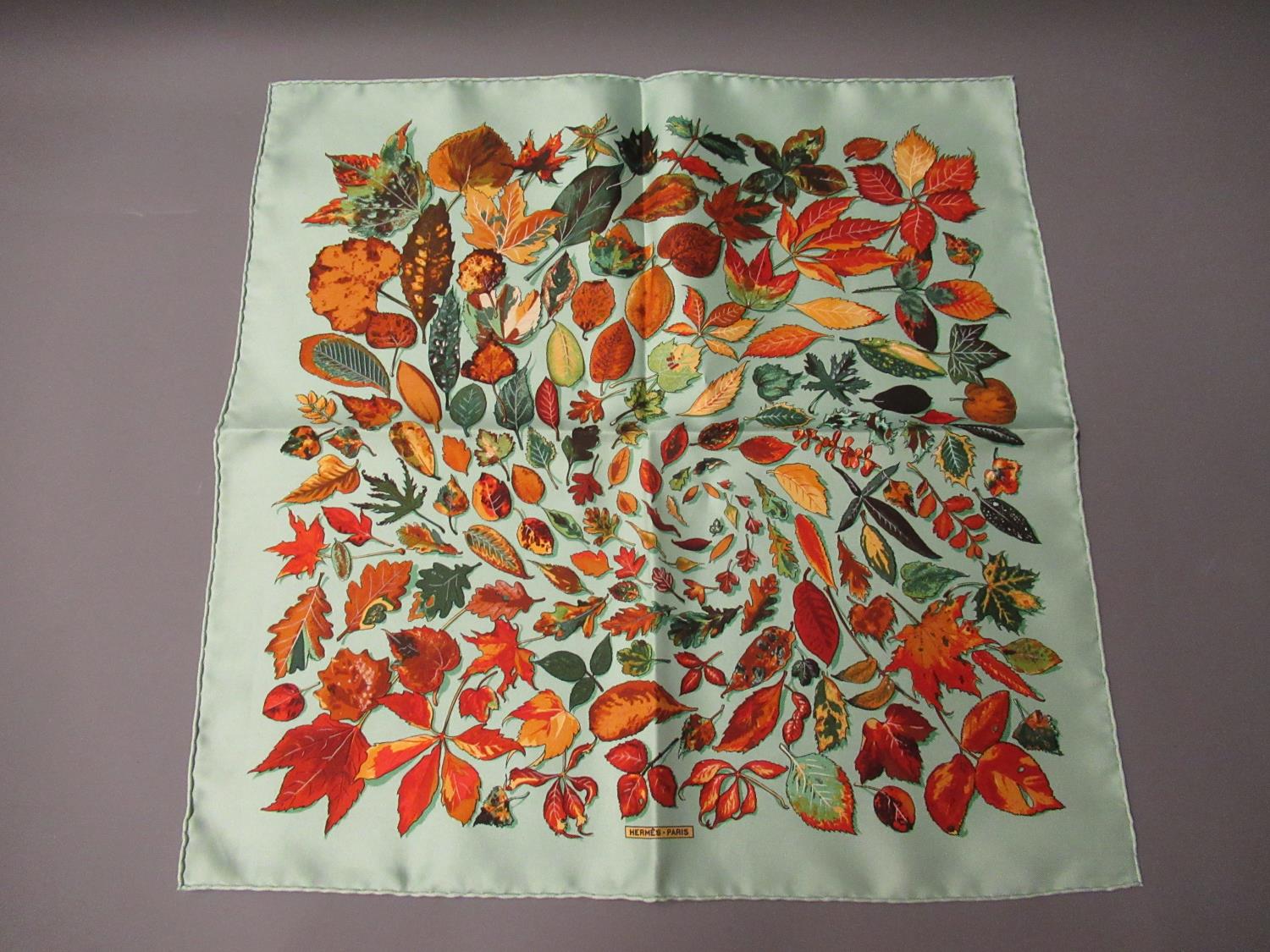 Hermes silk kerchief, autumn leaves on pale green ground, 42cms square, in a Hermes box