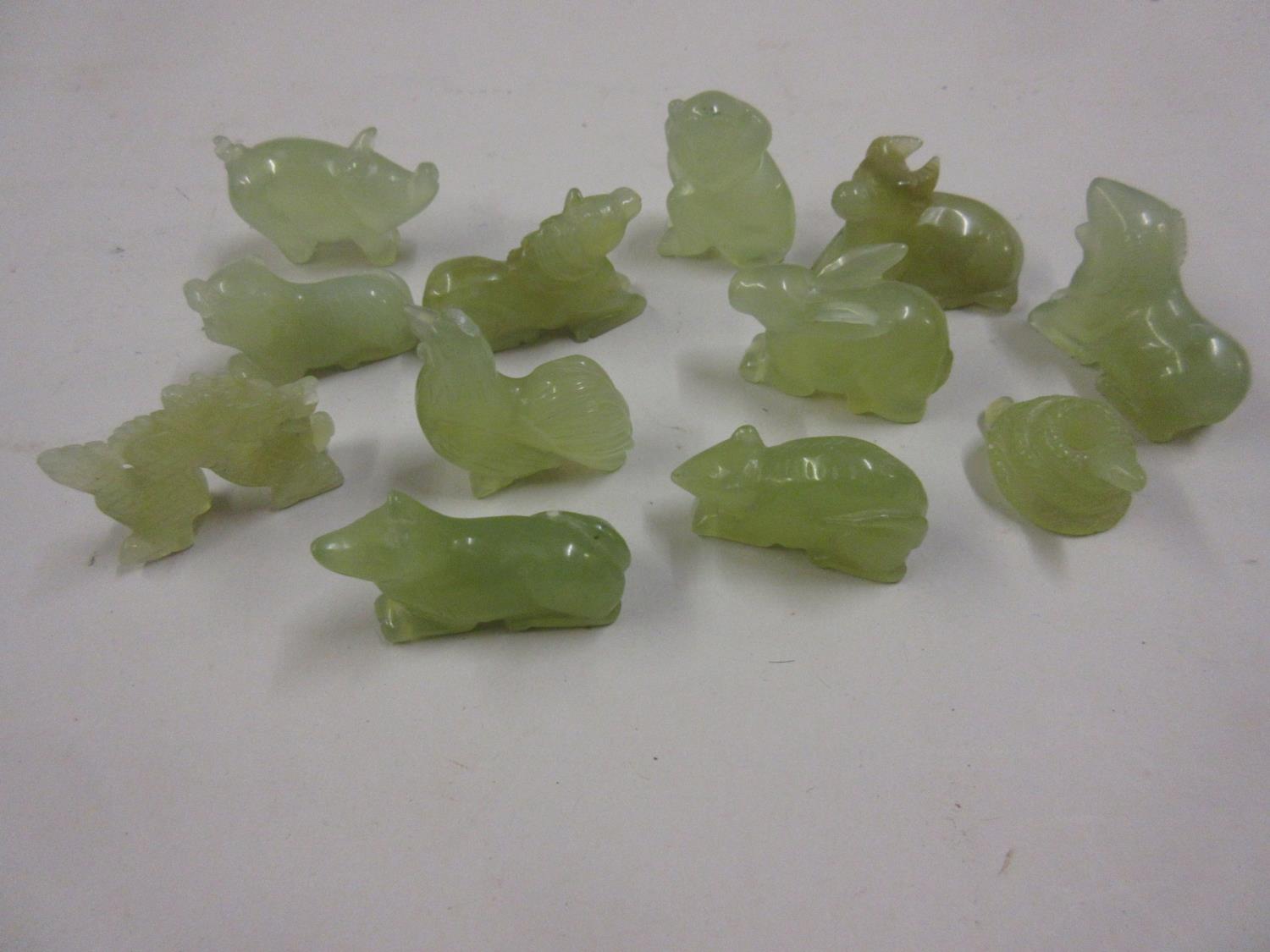 Group of twelve small carved jadeite figures of animals representing the Chinese year, snake, rat,