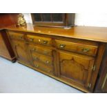 Good quality reproduction oak dresser base in George III style, the moulded top above four centre