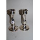 Pair of Birmingham silver baluster form circular candlesticks with inscription (one at fault)