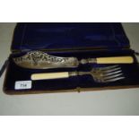 Cased pair of silver fish servers with pierced and floral engraved blades (case at fault)