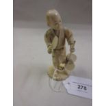 Small 19th Century Japanese carved ivory figure of a fan seller, 4.75ins high